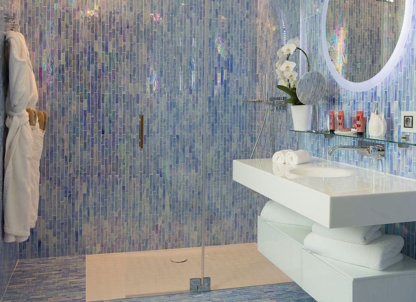Goralska Résidences Paris Bastille bathroom with blue mosaic tile shower and floating white vanity