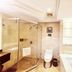 Shahai International Hotel Shanghai bathroom with glass shower, bathtub, toilet and mirror