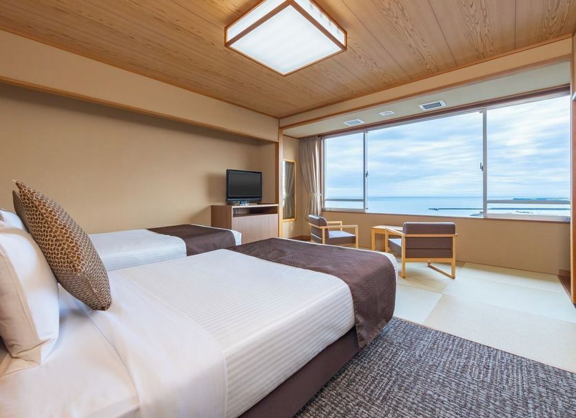 Kamenoi Hotel Yaizu guest room with twin beds and ocean view in Yaizu