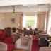 Hotel Bemelmans in Schin op Geul lounge with red carpet and rows of armchairs by a large window