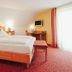 Landgasthof & Land-gut-Hotel Zur Rose in Ehingen guest room with twin beds, desk and window light