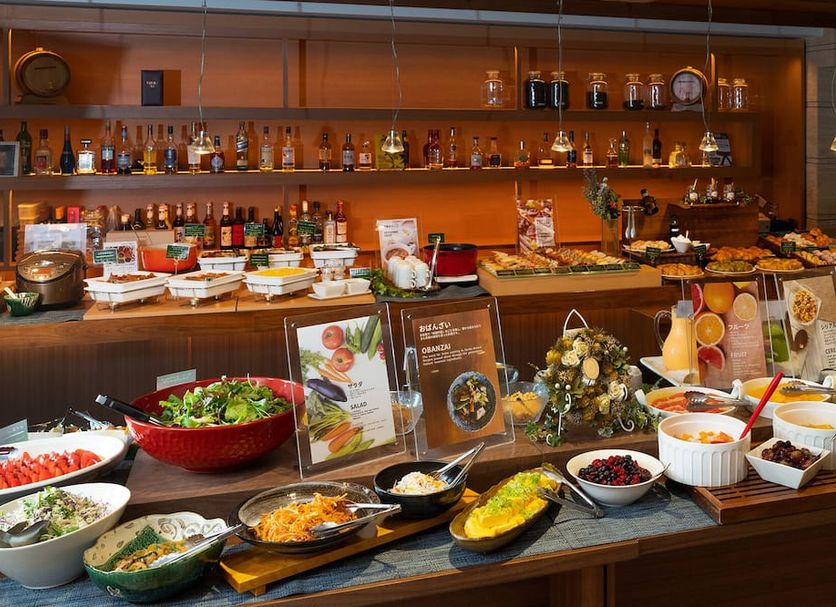 Sakura Terrace Kyoto breakfast buffet with salads, hot dishes, fruit, and drinks in a warm dining area
