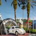 Disney's All-Star Movies Resort in Bay Lake with a giant race car, palm trees, and colorful movie-themed buildings