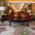 Aston Manado Hotel lobby seating area with red sofa, patterned rug and table lamps in Manado