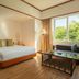 Centara Life Hotel Mae Sot guest room with king bed, sofa, and large window to greenery