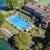 Aerial view of Hotel L'Approdo in Pettenasco with lakeside pool and terrace