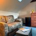 Whiteface Farm Adirondack Bed and Breakfast in Wilmington: cozy room with floral sofa, trunk table, mini fridge