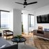 Mint House Dallas Downtown By Kasa suite with city view, sofa, TV and modern seating in Dallas