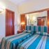 Raeli Hotel Lazio Rome guest room with two twin beds and striped blue-green bedding