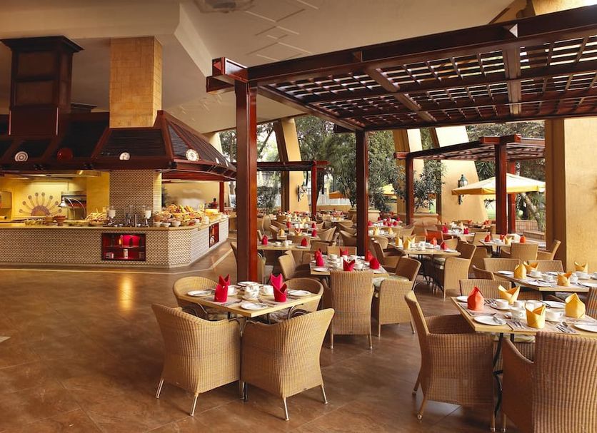 Soho Hotel & Casino at Sun City Resort restaurant with open-air dining and set tables