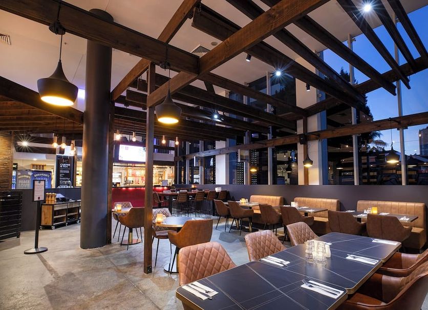 Sage Hotel Wollongong rooftop dining area with city views and exposed timber beams in Wollongong