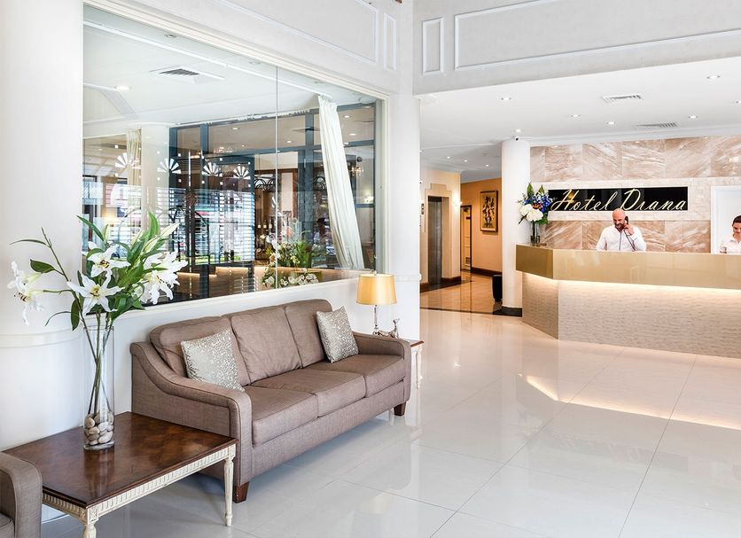Hotel Diana Woolloongabba lobby in Brisbane with reception desk, sofa seating, and bright modern interior
