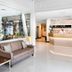 Hotel Diana Woolloongabba lobby in Brisbane with reception desk, sofa seating, and bright modern interior