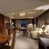 Hotel Kuva Chateau Taoyuan City suite with dining table, bedroom, sitting area and city view