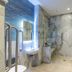 The Lane Hotel Edinburgh bathroom with walk-in shower, marble-look tile, heated towel rail and sink