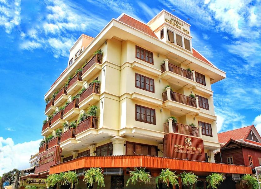 Cheathata CTA Hotel Siem Reap exterior with balconies and potted greenery under a bright blue sky