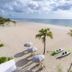 Tides Inn Hotel in Lauderdale-by-the-Sea with white sand beach, palm trees, umbrellas and kayaks