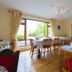 Aisleigh Guest House in Leitrim dining room with set tables and large garden-view window