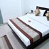 OYO 3815 Hotel Jaisingh Palace in Indore room with double bed and patterned cushions