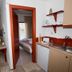 Panorama Junior Suites in Kavála: suite kitchenette and doorway to a bedroom with balcony view.
