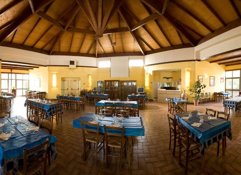 hu I Pini village in Fiano Romano dining room with wooden vaulted ceiling and many set tables