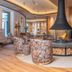 Ferienhotel Sonnenhof in Zell am Ziller lounge with central fireplace and patterned armchairs