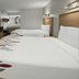 Red Roof Inn Greensboro Airport room with two beds, TV, and desk in Greensboro