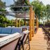 Hotel Hoogeveen outdoor terrace with wooden deck seating and shaded dining area in Hoogeveen