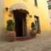 Albergo Umbria in Città di Castello entrance with potted plants and awning on a cobblestone street