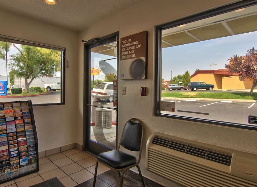 Motel 6 Sacramento North lobby with front desk windows and parking lot view in Sacramento