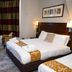 New Wilmington Hotel Eastbourne guest room with double bed, desk, seating area and large windows