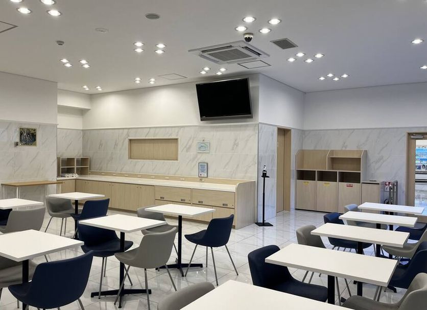 Toyoko Inn Tobu Utsunomiya eki Nishi guchi breakfast area with tables, chairs, counter and wall-mounted TV in Utsunomiya