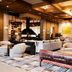 The Junto in Columbus lounge with leather bench, sofas, wood ceiling and fireplace