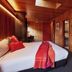Iron Creek Bay Estate in Sorell: cozy wood-paneled room with king bed, wall-mounted TV, and chair