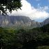 Riversong Guest House, Cape Town, with mountain views and lush greenery under a blue sky.
