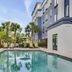 SpringHill Suites by Marriott Jacksonville North I-95 Area pool courtyard with palm trees and loungers