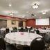 Meeting room at Country Inn & Suites by Radisson, Little Falls, MN with round banquet tables and projector screen