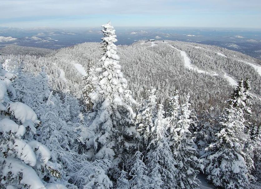 Gore Mountain Lodge in North Creek with snowy mountain forest and distant landscape views