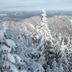 Gore Mountain Lodge in North Creek with snowy mountain forest and distant landscape views