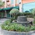 The Loom Rangsit in Pathum Thani, landscaped hotel courtyard with stone fountain and greenery