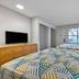 Studio 6 Ft Worth - North Richland Hills guest room with two beds, TV, dresser and window