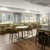 Fairfield by Marriott Inn & Suites Portland West/Beaverton breakfast area with tables and bench seating in Beaverton