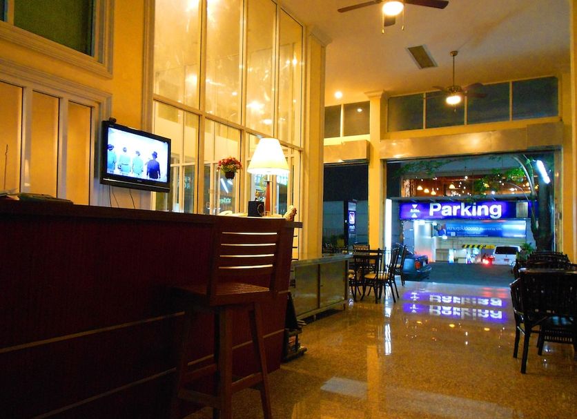Lodge 61 Hotel Bangkok lobby with polished floors, seating, and view of parking entrance