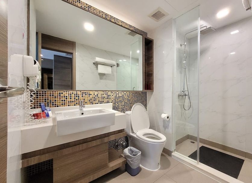 Citrus Sukhumvit 11 by Compass Hospitality bathroom with vanity, toilet, and glass shower in Bangkok