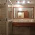 Lujan de Cuyo B&B bathroom with glass shower, double sink vanity and large mirror in Luján de Cuyo
