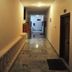 Hotel Casa di William in Khajurāho hallway with marble floor and warm lighting