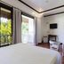 Lanterna Hotel Boracay room with balcony door, wicker chairs, TV and garden view in Boracay