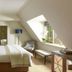 Danesfield House Hotel And Spa in Marlow bedroom with sloped ceiling, skylight, king bed and window seat