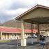 Executive Inn Rocky Top covered entrance and parking lot with mountain backdrop