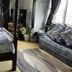 The Leather Bottle in Gravesend: bedroom with four-poster bed, sofa, TV and patterned rug
